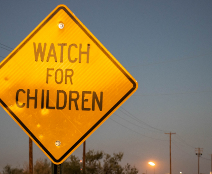 Watch for children sign. Down the road from a neighborhood safety sign, a flare burns in Midland County, Texas, on Oct. 30, 2021. More than 1.7 trillion cubic feet of natural gas was flared in Texas between 2012 and 2020, according to a Howard Center analysis of satellite data.