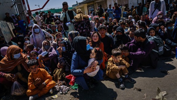 A large group of seated refugees