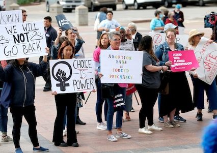 Abortion rights supporters protest Tuesday at the state Capitol in Oklahoma City as lawmakers moved to make performing an abortion a felony punishable by prison time.