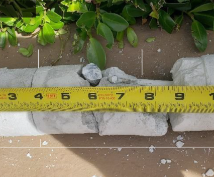 A core sample of the condo's concrete being measured