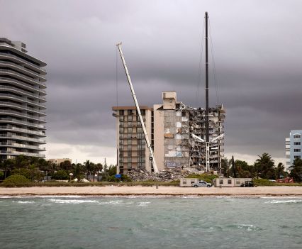 A view of the Surfside condo from the ocean with two cranes in front