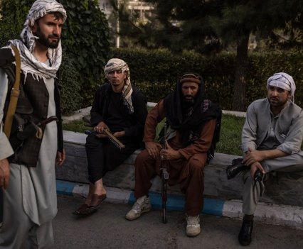 Taliban members in Kabul, Afghanistan, on Sunday. As the militants moved into the capital, police posts were abandoned and posters of women at beauty salons were painted over