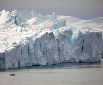 Icebergs dwarf a fishing boat in Disko Bay outside of Ilulissat on Aug. 10, 2021. The giant ice sculptures are pieces that have broken off Ilulissat Glacier, also known as Jakobshavn, 40 miles inland.
