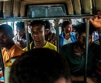 A number of people packed into a taxi bus