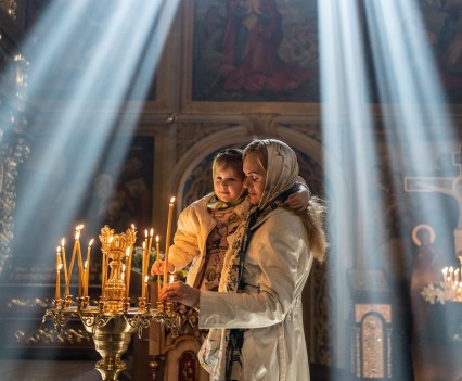 Maria Shevchenko and her daughter Zlata celebrate Easter at the Mikhailovsky Cathedral of the Ukrainian Orthodox Church