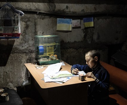 Tymophey, 8, painitng in the basement of the kindergarden. The village of Kutuzivka was occupied by Russia for weeks and was recently liberated by Ukrainain army on April 27, 2022. Village was heavely destroyed during the battlefield, and people still living in basement in fear of future shellings