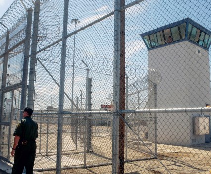 A correctional officer walks near one of two entrances to Kern Valley State Prison in Delano