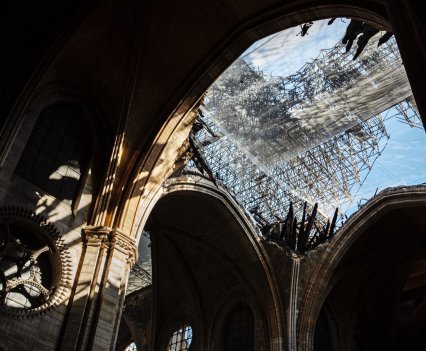 A hole caused by fire damage in the ceiling of the Notre Dame Cathedral where the spire used to be.