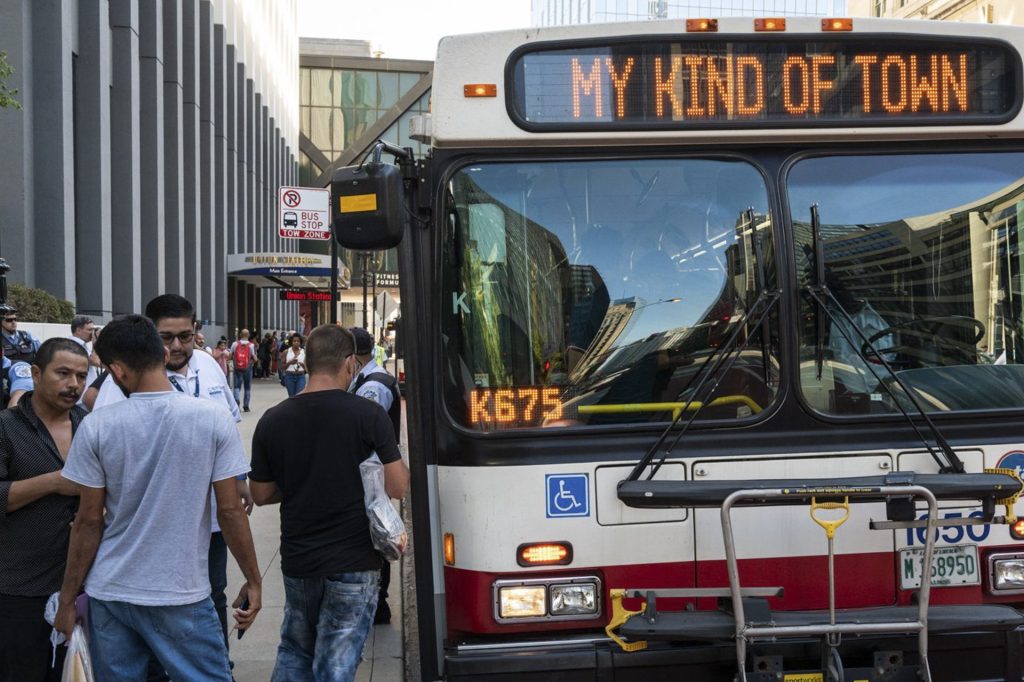 A CTA bus shuttle reads “My Kind of Town” as migrants disembarked a bus at Union Station after a 25-hour-long ride from Texas Sept. 9, 2022