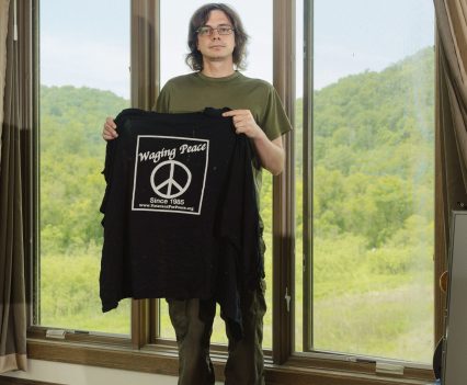 Photographed in June 2022 at his home in La Crosse, Wis., Olsen displays the “Veterans for Peace” shirt he was wearing when police shot him. Lyndon French for Long Lead