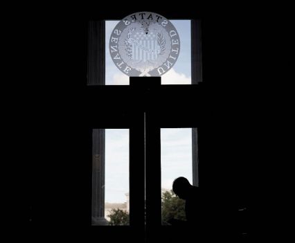A silhouette of a man sitting at the entrance to the senate