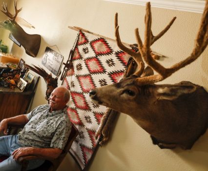 John Hawk sits at his company’s office in Holtville, where taxidermy decorates the walls. (Robert Gauthier / Los Angeles Times)