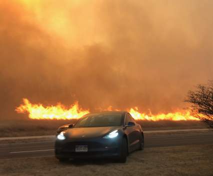 As the fire sweeps east, a driver hops the median of Dillon Road near the Coal Creek Golf Course in Louisville.