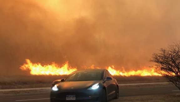 As the fire sweeps east, a driver hops the median of Dillon Road near the Coal Creek Golf Course in Louisville.