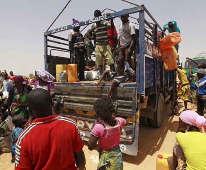 People displaced by the insurgency board a truck in the town of Geidam to travel back to their home states in May 2015. The war between the government and Islamist extremists has raged for 13 years, leading to economic collapse and hunger in much of the northeast. REUTERS/File photo