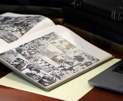 The 1933 DePaulian yearbook, with photos of high school students in blackface, sits open on the reading room table with other yearbooks that gave insight into DePaul’s student life at the time. (Cam Rodriguez)