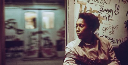 An African-American woman sits inside a subway car which has been marked with extensive graffiti, New York City, New York, 1973. Image courtesy National Archives. (Photo via Smith Collection/Gado/Getty Images).