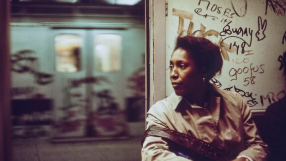 An African-American woman sits inside a subway car which has been marked with extensive graffiti, New York City, New York, 1973. Image courtesy National Archives. (Photo via Smith Collection/Gado/Getty Images).