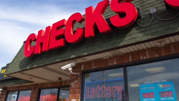 All Checks Cashed in Everett, Massachusetts, is one of nearly 150 businesses licensed by the state of Massachusetts to cash checks and sell lottery tickets. Check cashers sold nearly $36 million in lottery products from 2017 through 2020. (Garrett Adamtsev/Boston University)