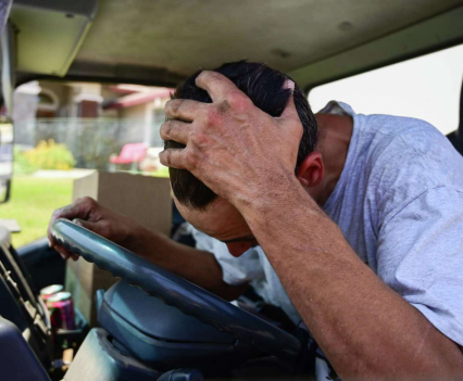 Evan Thompson, an installer with A 100% Guarantee Heating & AC, puts his face to the fans inside the truck to cool off in Vacaville during a heat wave last year.