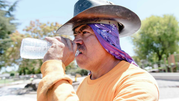 Roy Alvarado with Goodline Landscaping of Tracy takes a drink while working on a playground renovation in Livermore in 2019.