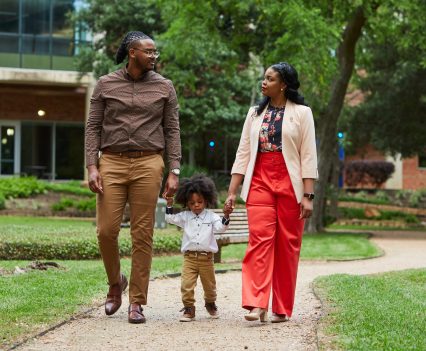 Marcqwon and Rosandra Daywalker and their 2-year-old son, Rexton, walk outside the Texas Medical Center in Houston.