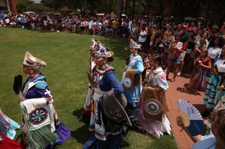 A group of Lumbee women and girls enter a dance circle at a pow wow during the annual Lumbee Homecoming.