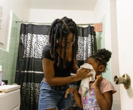 Williams gets her daughter Indya, 5, ready for bed.