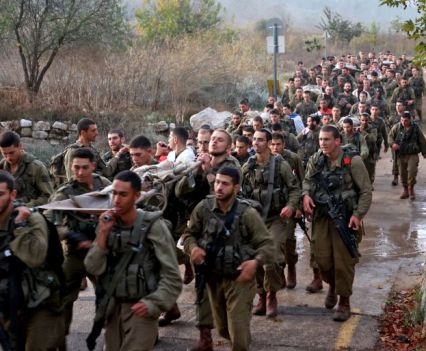 Newly-recruited Israeli paratroopers march in full combat gear on a 50-kilometre 12-hour hike in the mountains near Jerusalem on November 10, 2022.