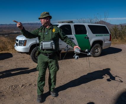 A Border Patrol agent demonstrates the Lockheed Martin Indago-3, a smaller drone used to track migrants through the desert.