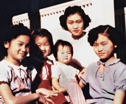 CONNIE CHUNG, CENTER IN A PINK DRESS, WITH HER SISTERS.