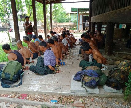 A photo from May 10 showing about 30 men with their hands tied behind their backs on the grounds of Mon Taing Pin monastery was recovered from the phone of a Myanmar soldier. The location was photographed several days later by villagers after the troops had torched some houses and left.