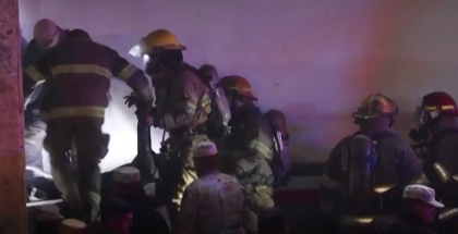 Firefighters pulling bodies from the fire