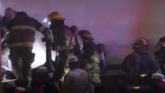 Firefighters pulling bodies from the fire
