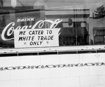 A “We Cater To White Trade Only” sign hanging in the window of the Denver Cafe in North Portland