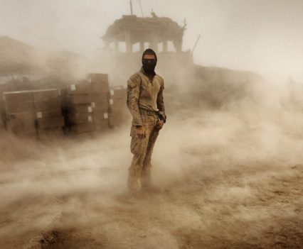Private First Class Brandon Voris, 19, of Lebanon, Ohio, from the First Battalion Eighth Marines Alpha Company stands in the middle of his camp as a sandstorm hits his remote outpost near Kunjak in southern Afghanistan's Helmand province, October 28, 2010