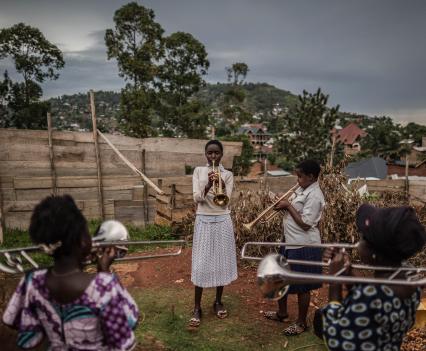 Girls playing music in a church yard in Beni. So far more than 1,100 people have died in the outbreak, according to the World Health Organization.