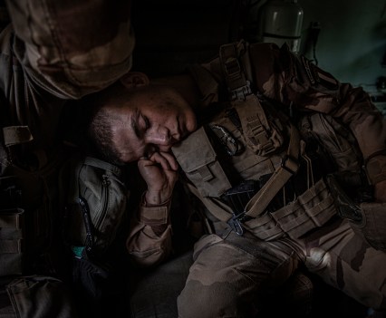 A French Foreign Legion soldier from the Operation Barkhane Counterterrorism Force sleeps inside an armoured personnel carrier during a mission to hunt down Islamic militants in northeastern Mali near the border with Niger. When French troops first arrived in Mali in 2013 to rout armed Islamists from its northern cities, they thought they would be gone in six months. Seven years later, troop numbers have swelled to 5,100, and the French have had to extend their fight to two more countries, Niger and Burkina Faso. Despite having killed over 600 ÔterroristsÕ since 2015, their enemies, groups loosely allied with Islamic State and Al Qaeda, have spread and have stepped up their attacks, particularly on national military bases. Between December and January, 174 Nigerien soldiers were killed in multiple attacks in Niger alone. According to UN figures, the jihadist attacks in Mali, Niger, and Burkina Faso killed 4 000 people in 2019 and caused an unprecedented humanitarian crisis.