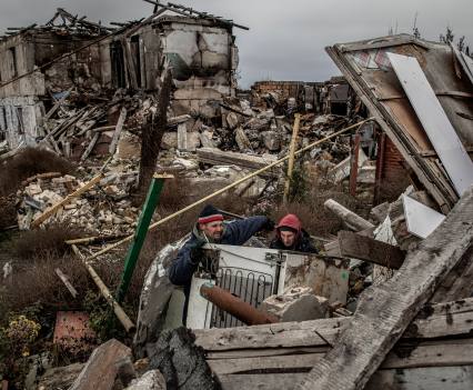 Salvaging a refrigerator from the ruins of a home in the southern village of Posad-Pokrovs'ke, December 3, 2022. The village was a frontline Ukrainian position during the counter-offensive to retake Kherson and was heavily bombarded by Russian forces, leaving almost no buildings undamaged.