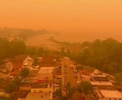 Photo of the orange haze in a town caused by wildfire smoke