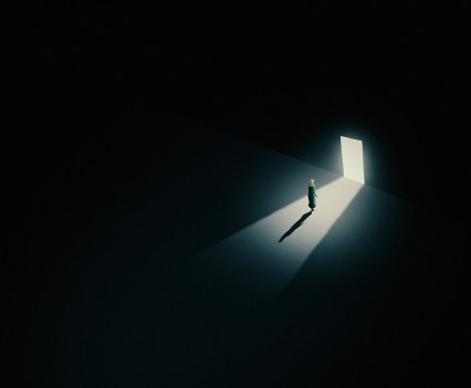 Graphic of veiled muslim woman in a dark room standing in front of a single door with light flooding through