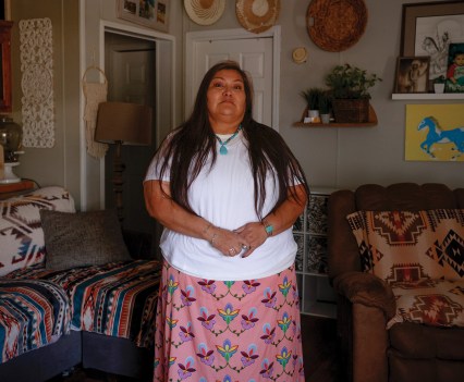 Photo of a Native American woman in home standing and facing the camera