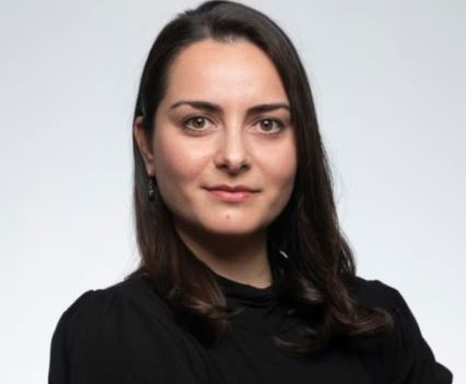 Photo of a woman wearing black of plain white background