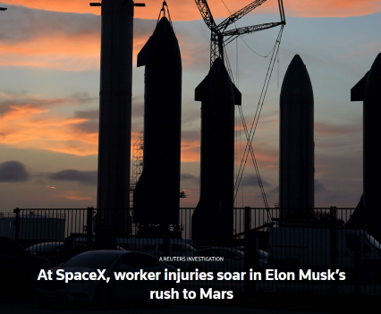 Silhouette of SpaceX launchpad against a sunset with orange clouds.