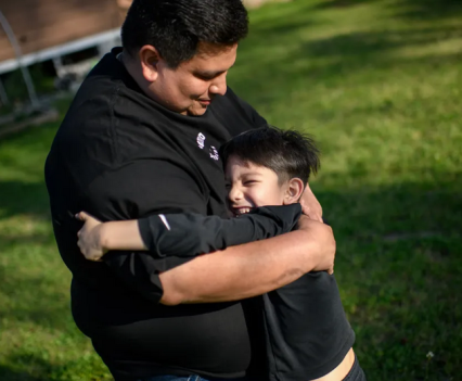 George Galindo hugs his 5-year-old son, George Junior