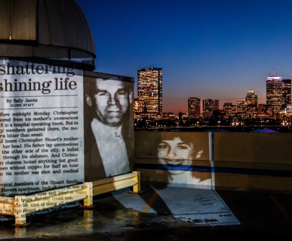 The front page of The Boston Globe from Oct. 25, 1989 — featuring Charles and Carol Stuart — is projected with the Boston city skyline.