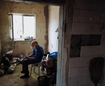 Volodymyr Burykin in the hall of his destroyed home.