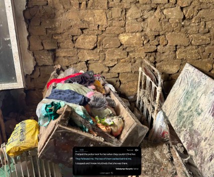 Destroyed furniture and clothing litter the floor of a stone house after a flood