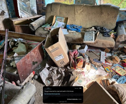 Personal possessions and trash are piled all over the floor of a ruined home