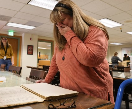 Davidson reacts when she sees her great-grandmother’s name, Lillian Hansen, in the patient log from Northern State Hospital at the Washington State Archives in Olympia. She found her name in the files titled “Report of Movement of Population, Northern State Hospital.”